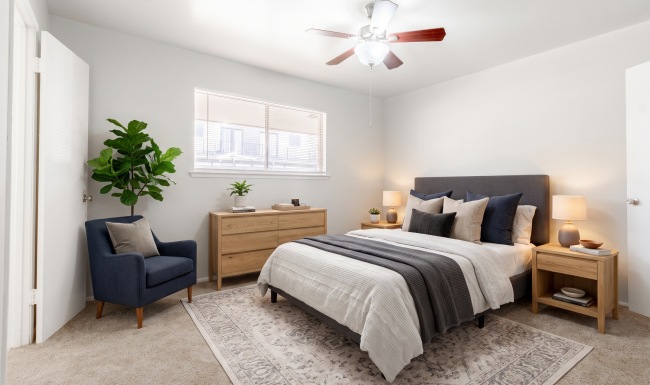Bedroom with natural lighting and ceiling fans