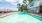 Resort-style swimming pool with lounge seating